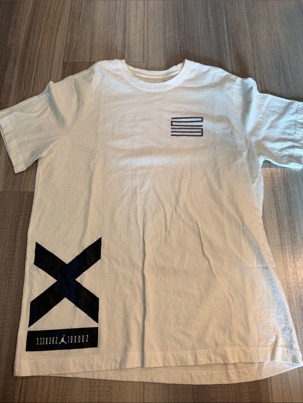 Jordan White Short Sleeve Tee with Black Graphic 'X' and Chest Stripes